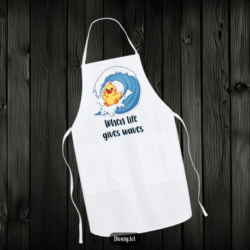 Funny duck wave apron showing a surprised rubber duck character crashing into a giant wave, a comedic kitchen essential.